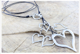 Unique Cascade of polished Handmade hearts on 2 strands of leather cord, Necklace - simple to stunning